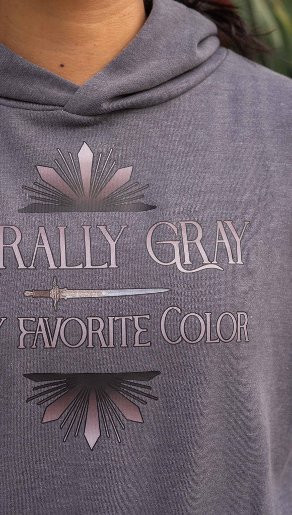 Zoomed in photo of girl wearing gray hoodie with the phrase, "Morally Gray is my Favorite Color" with a dagger and gray starburst detail printed above/below the text. The hoodie color is gray.