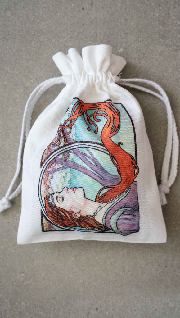 Matching Art Nouveau drawcord pouch by Scott Christian Sava. The painting features a woman wearing a crown and pearls with long flowing red locks; standing in front of a round window.