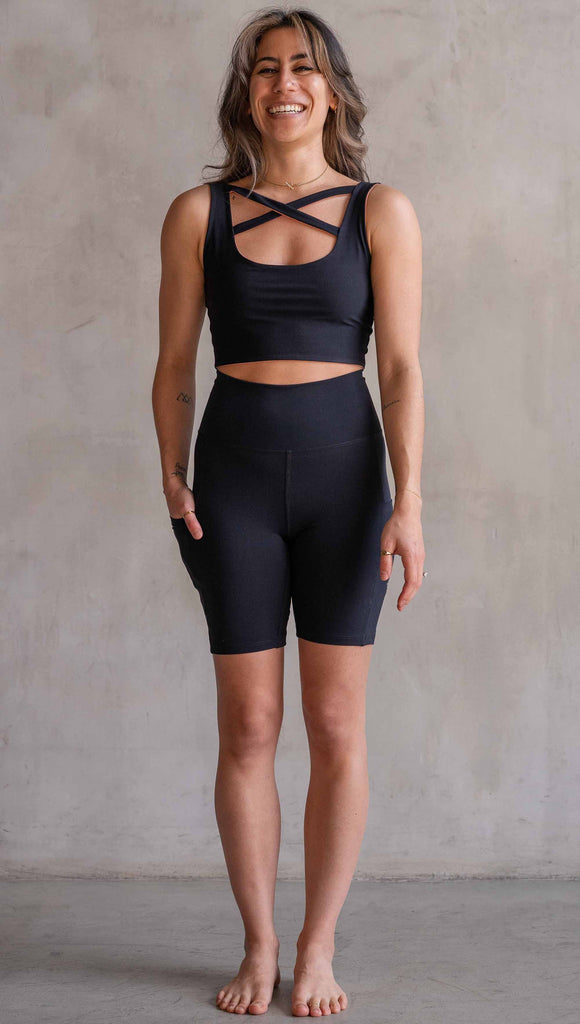 Model wearing WERKSHOP Black EnviSoft Bicycle Length Shorts with Pockets. Featuring flatlock seams and a small eagle logo on the wearer's left thigh.