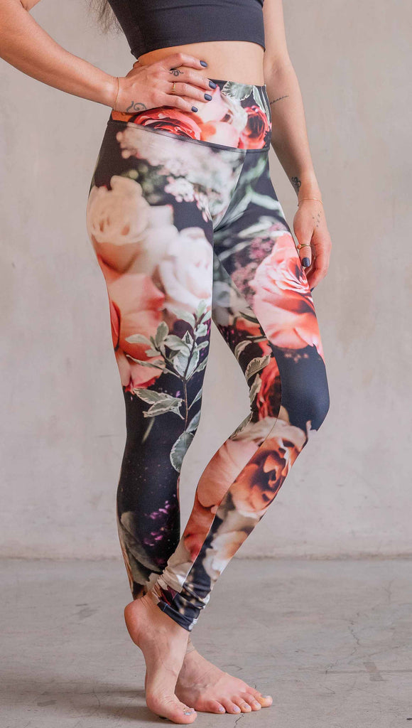 Model wearing WERKSHOP Bodacious Bouquet Athleisure Leggings. The leggings feature a floral bouquet with pink and white roses and leafy greens throughout