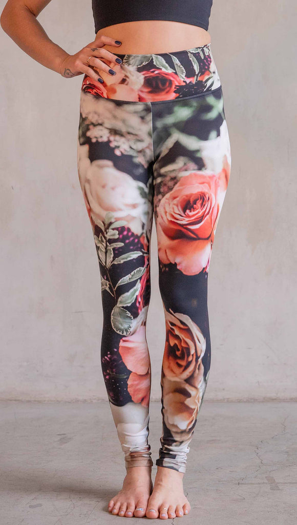 Model wearing WERKSHOP Bodacious Bouquet Athleisure Leggings. The leggings feature a floral bouquet with pink and white roses and leafy greens throughout