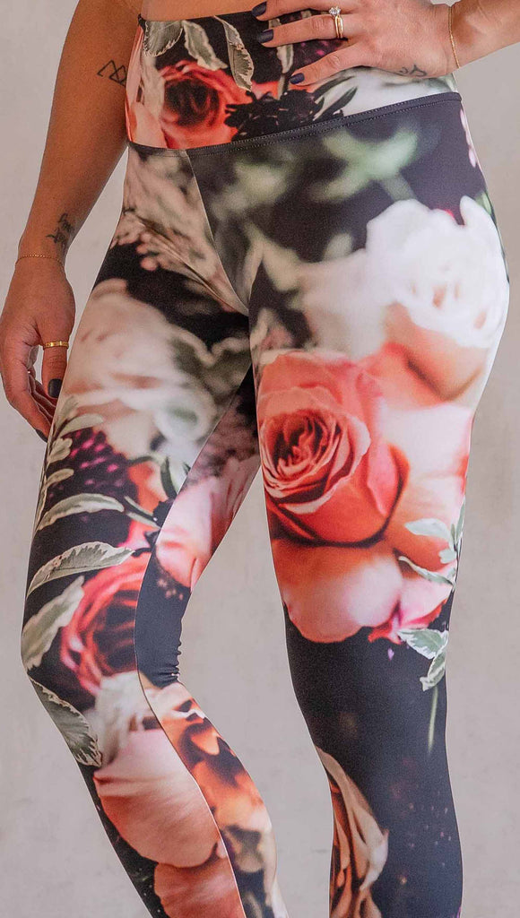 Model wearing WERKSHOP Bodacious Bouquet Athleisure Leggings. The leggings feature a floral bouquet with pink and white roses and leafy greens throughout