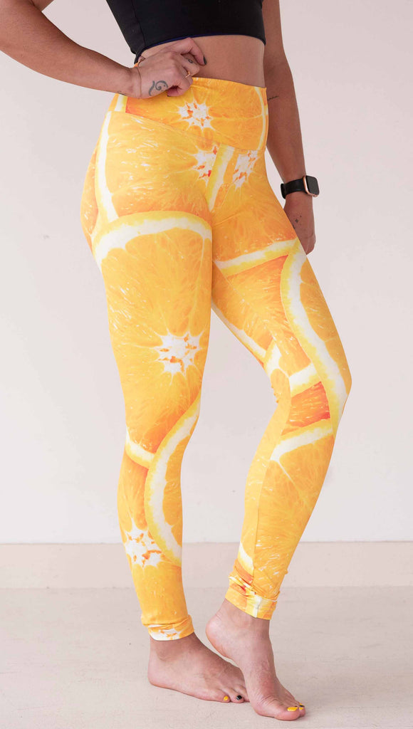 Model wearing WERKSHOP citrus leggings printed with a bright and bold macro image of meyer lemon slices.