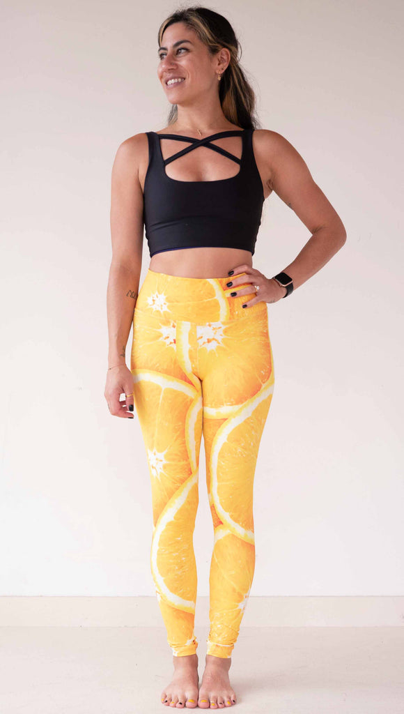 Model wearing WERKSHOP citrus leggings printed with a bright and bold macro image of meyer lemon slices.