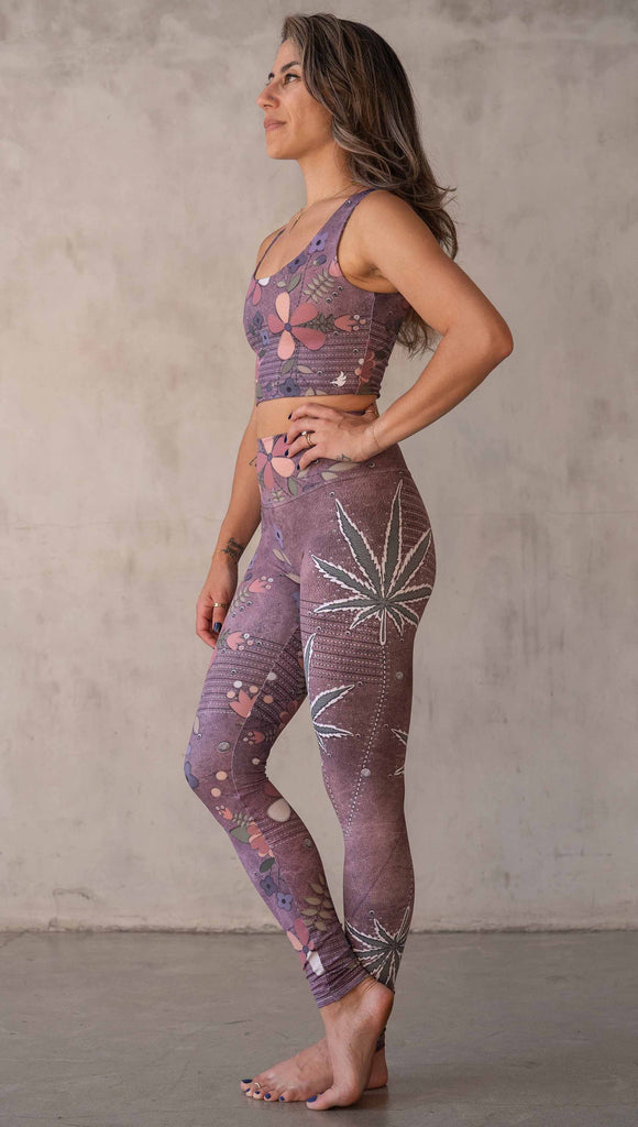 Model wearing WERKSHOP Dope + Flowers Mashup leggings. The leggings are printed with original artwork by Chriztina Marie. One leg features patchwork daisys over grainy mauve toned leather background. The other leg features marijuana leaves over a warm brown background. Both legs have faux stitching.