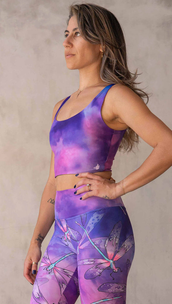 Model wearing WERKSHOP Butterflies and Dragonflies Reversible top. This image shows the "dragonflies" side with a purple and pink watercolor print. It matches our Dragonflies leggings.