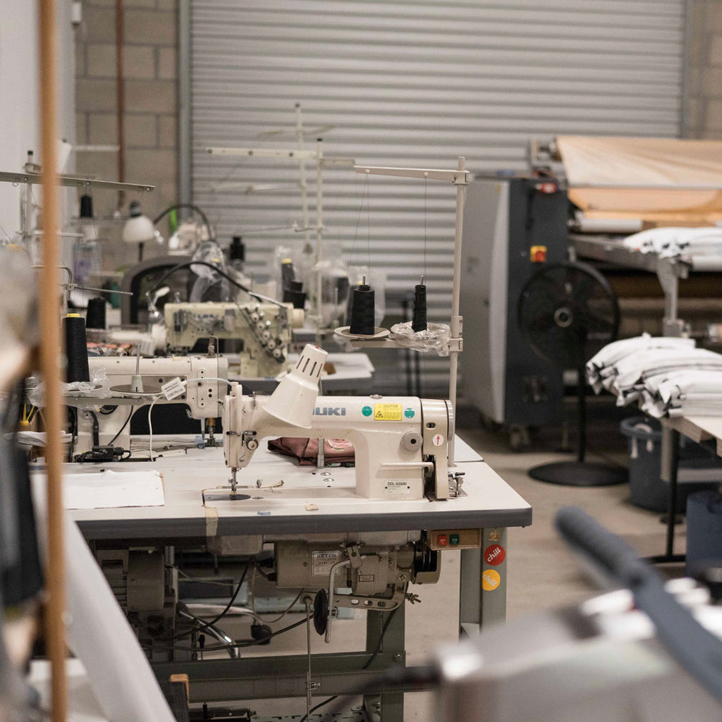 Photo of our small design studio with sewing machines and our industrial heat press (her name is Jozie)