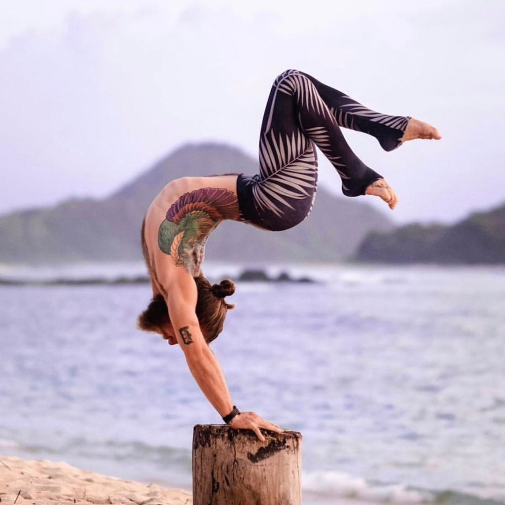 Werkshop Ambassador, Daniel Rama doing a handstand while wearing WERKSHOP Black Palms Athleisure Leggings