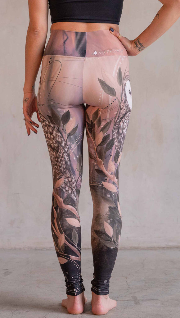 Model wearing WERKSHOP Owls Athleisure Leggings. The leggings are printed with a whimsical barn owl on the thigh surrounded by swirls and leaves on a mauve and cream toned background.