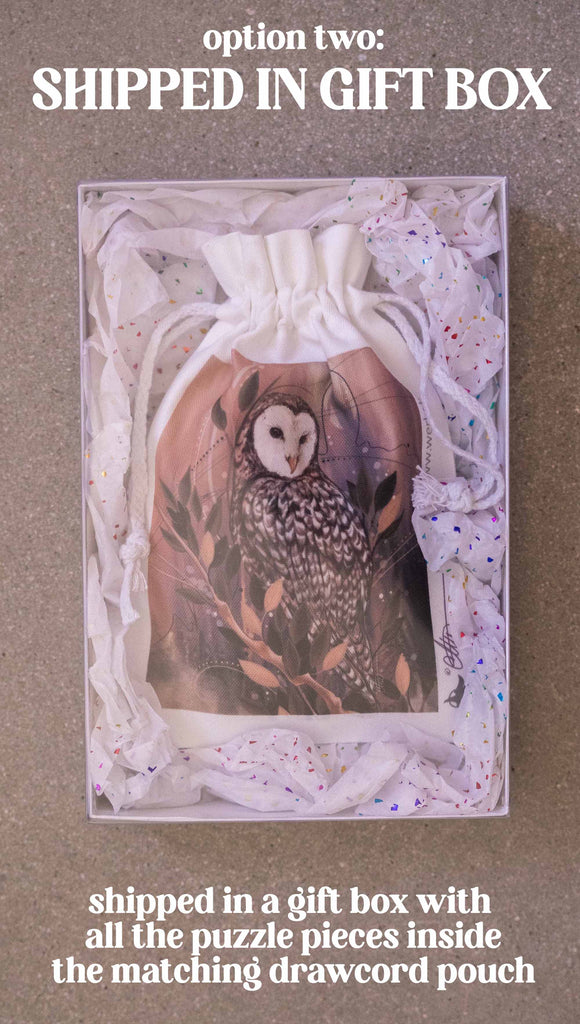 WERKSHOP Barn Owl 252 piece jigsaw puzzle. The puzzle is printed with original artwork of an Owl by Chriztina Marie. It features a barn owl perched on top of a branch with whimsical leaves. The overall color story is of mauves, warm browns and complimentary green leaves. Option 2: Shipped in a gift box with all the puzzle pieces inside the matching drawcord pouch.