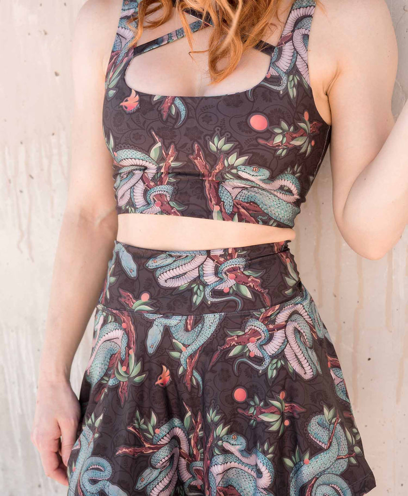 Model standing in front of distressed concrete wall while wearing WERKSHOP Pit Viper Featherlight Skirt Set.