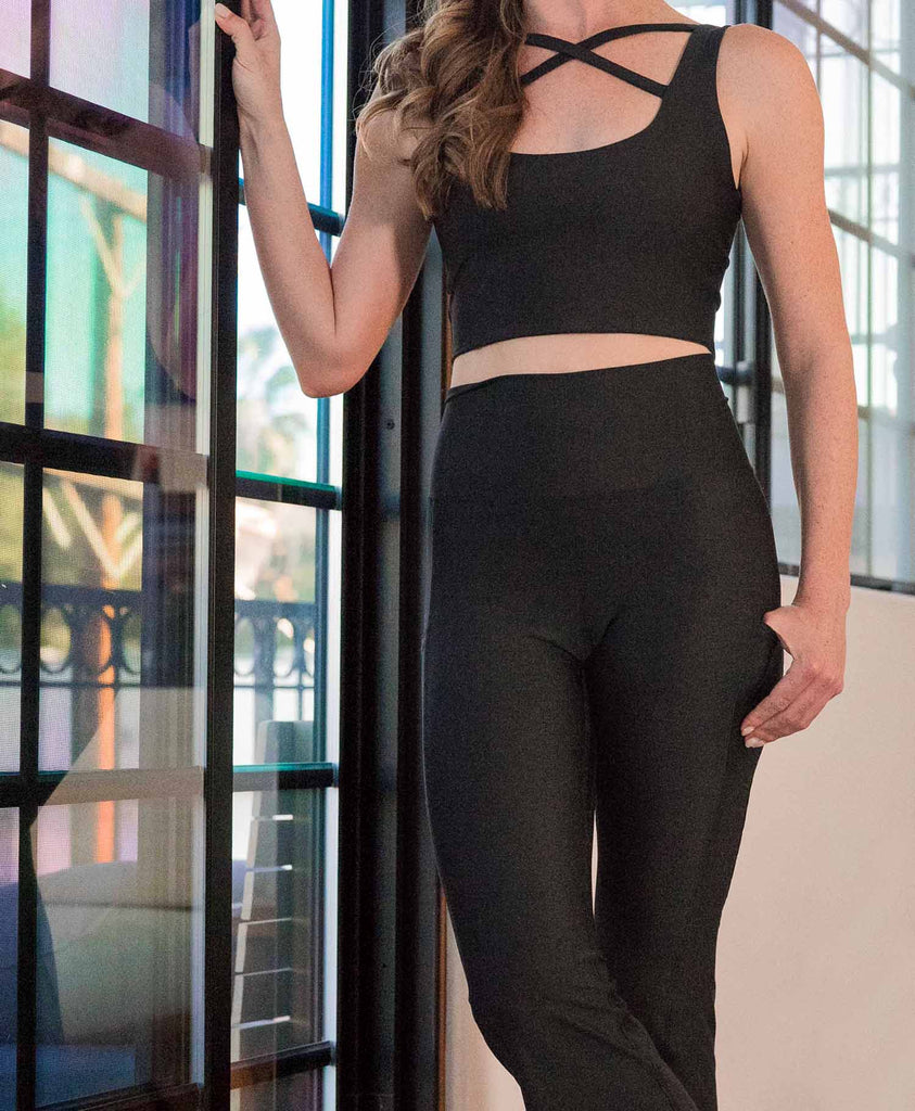 Girl standing in front of window wearing WERKSHOP Solid Black Featherlight Leggings Set.