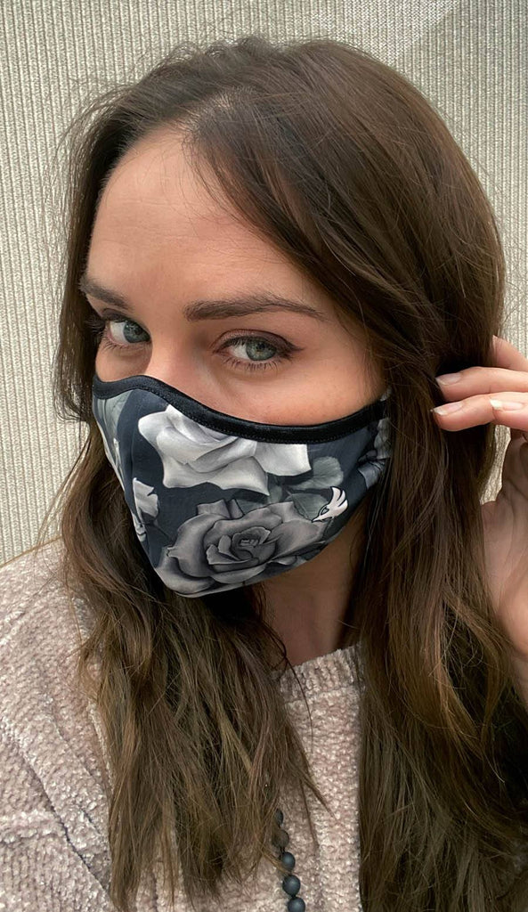 girl wearing face mask with black and white roses artwork