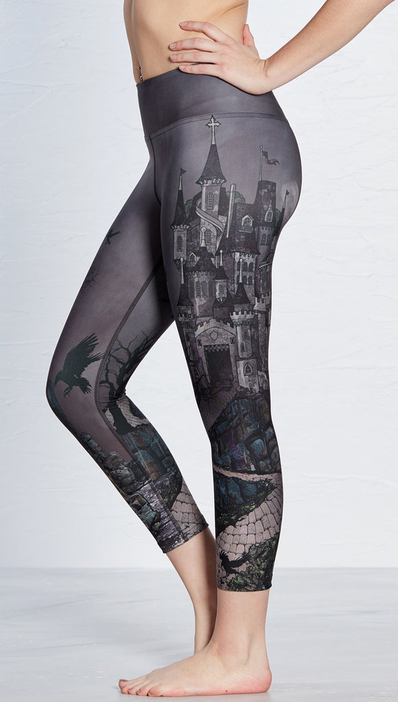 closeup left side view of model wearing castle design printed capri leggings