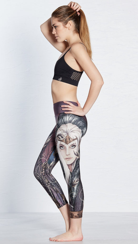 left side view of model wearing capri leggings with printed elf design