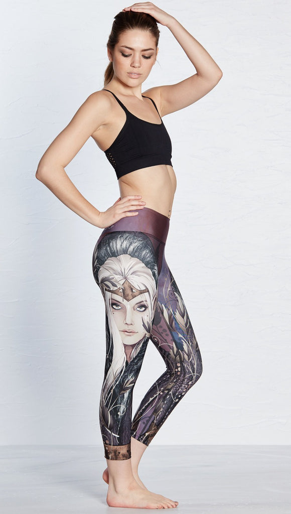 right side view of model wearing capri leggings with printed elf design