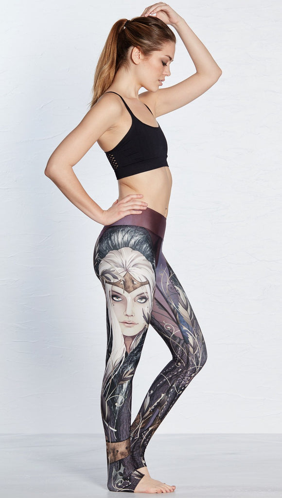 right side view of model wearing full length leggings with printed elf design