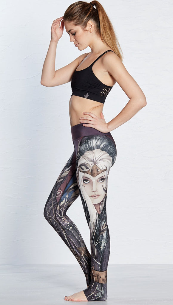 left side view of model wearing full length leggings with printed elf design