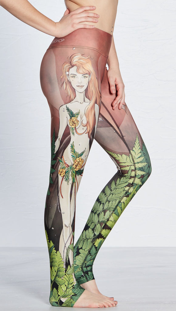 close up right side view of model wearing pixie themed printed full length leggings