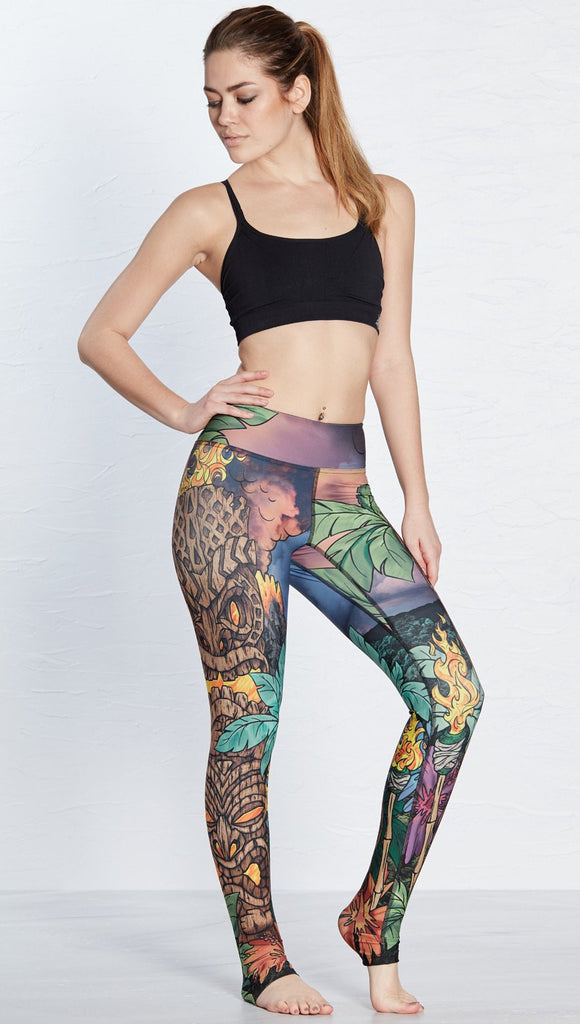 front view of model wearing island tiki themed printed full length leggings