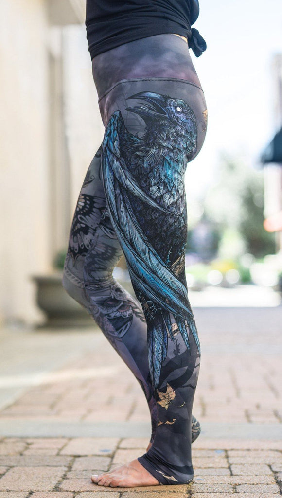 close up left side view of model wearing mashup gothic themed printed full length leggings