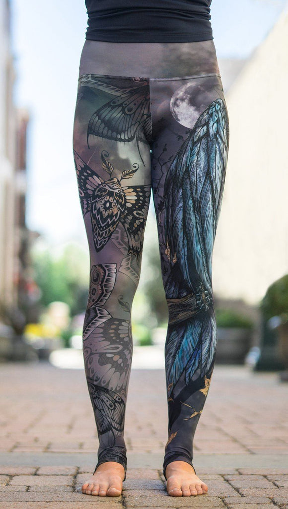 close up front view of model wearing mashup gothic themed printed full length leggings