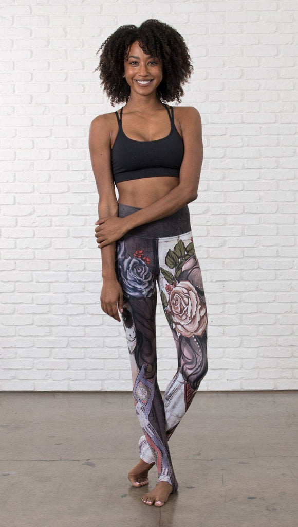 front view of model wearing mashup Sugar Skull and Dia De Los Muertos themed printed full length leggings