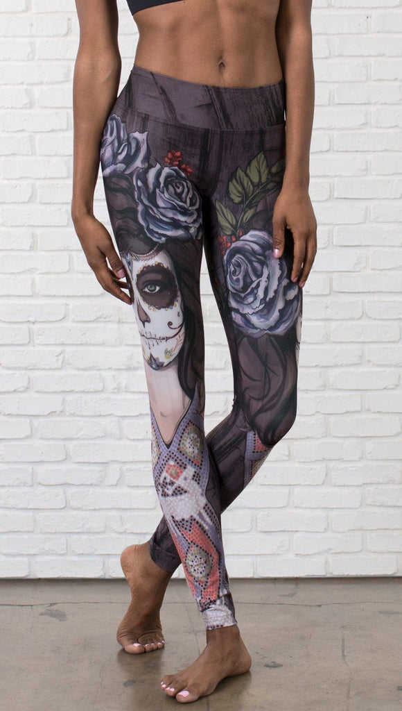 close up front view of model wearing sugar skull themed printed full length leggings