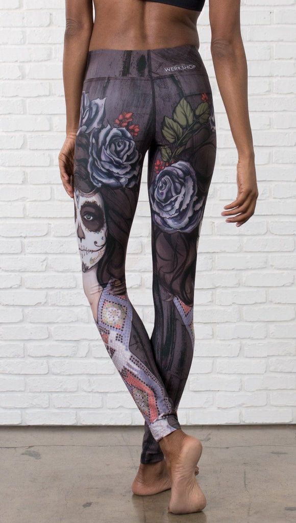 close up back view of model wearing sugar skull themed printed full length leggings