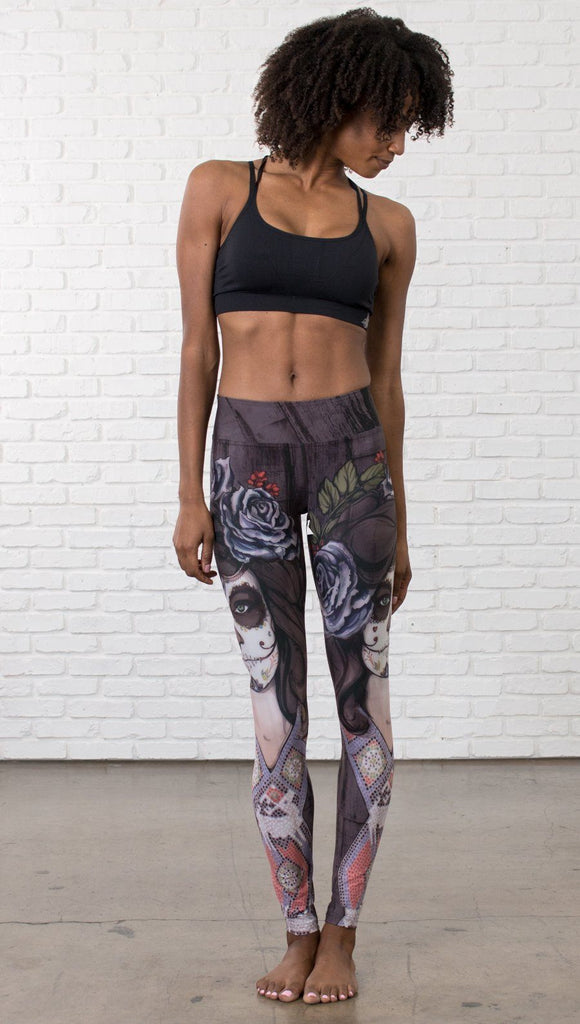 front view of model wearing sugar skull themed printed full length leggings