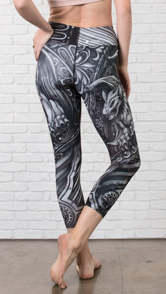 back view of model wearing gothic themed printed capri leggings