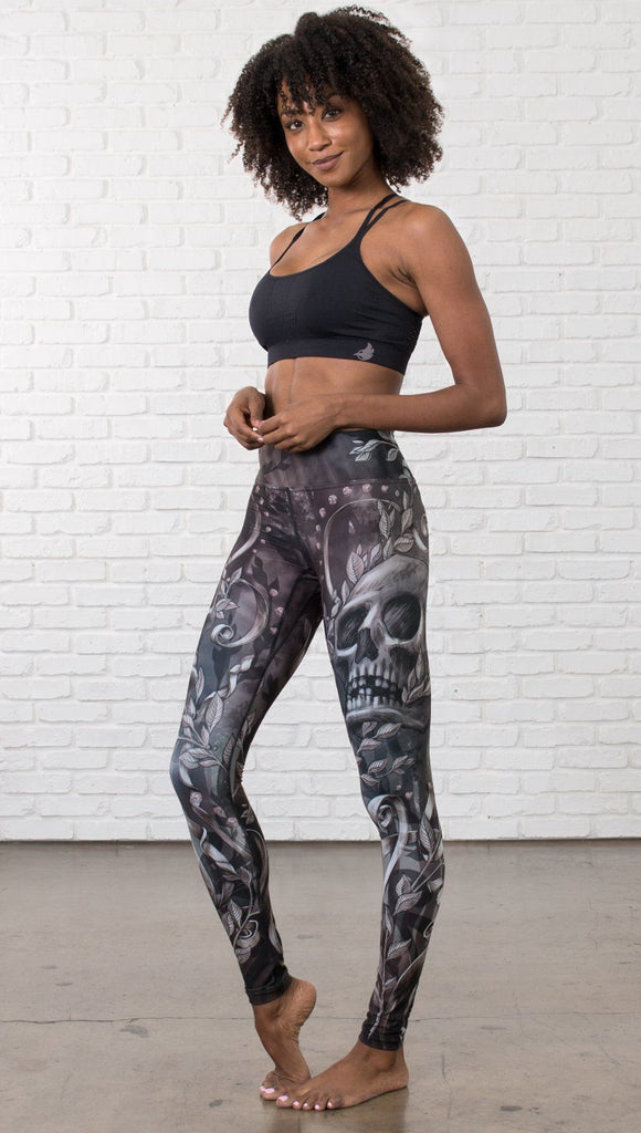 front view of model wearing gothic themed printed full length leggings