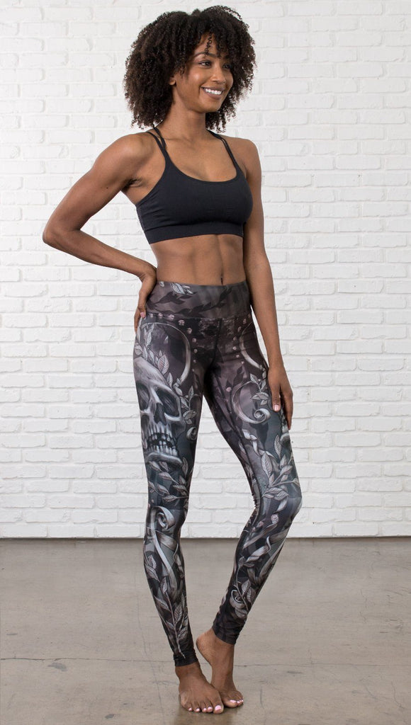 front view of model wearing gothic themed printed full length leggings