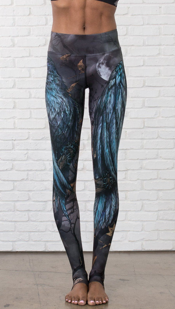 closeup front view of model wearing gothic themed printed full length leggings