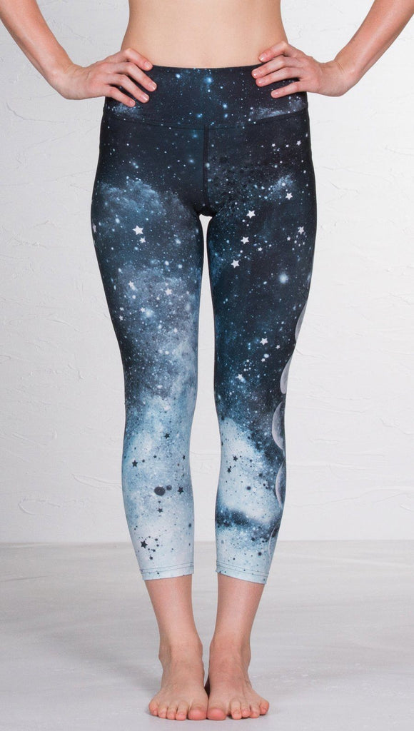 closeup front view of model wearing moon cycle design printed capri leggings