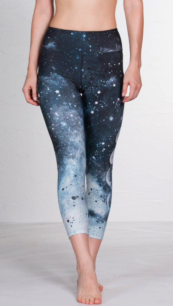 front view of model wearing moon cycle design printed capri leggings