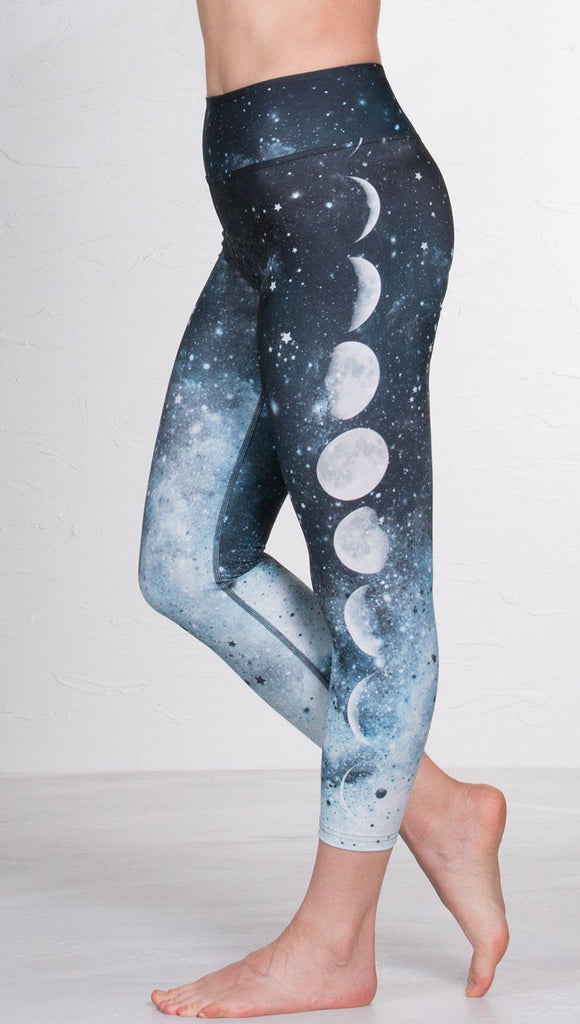 closeup left side view of model wearing moon cycle design printed capri leggings