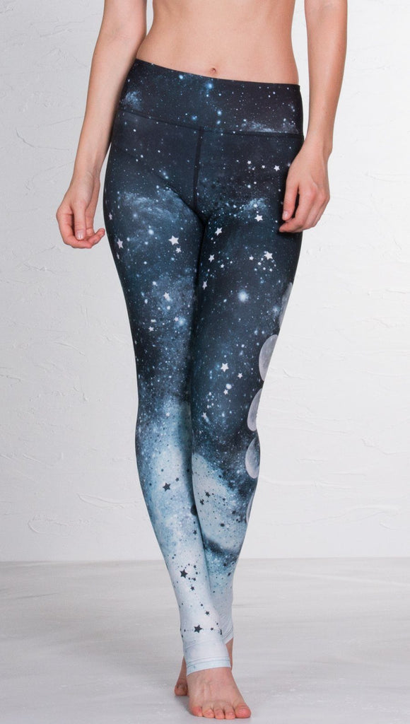 closeup front view of model wearing moon cycle design printed full length leggings