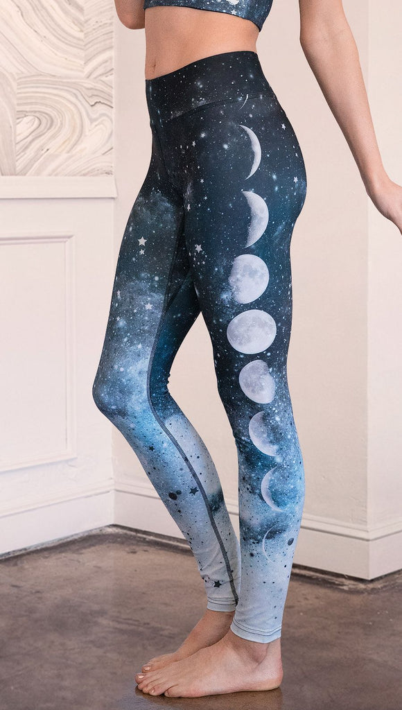 closeup left side view of model wearing moon cycle themed full length leggings