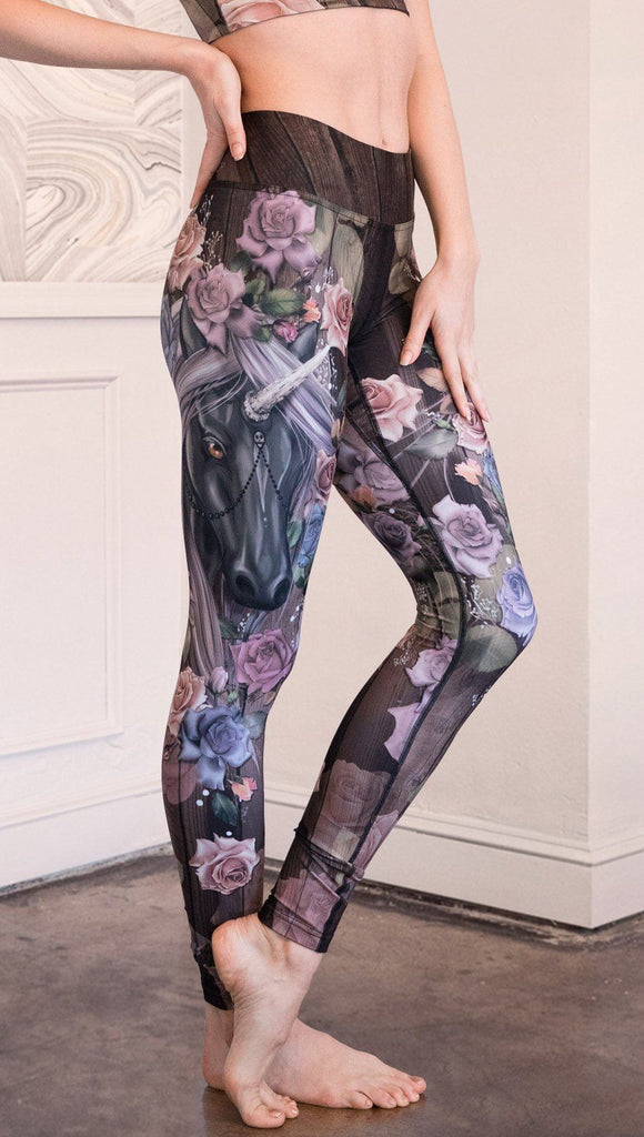 closeup side view of model wearing unicorn themed full length leggings