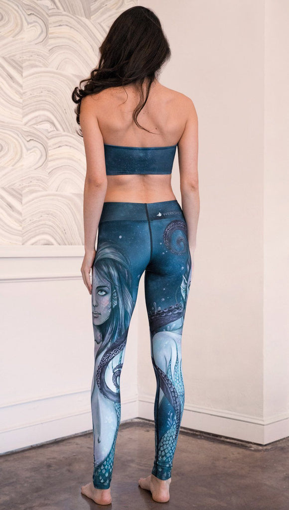 back view of model wearing full length leggings with mermaid and tentacles printed design