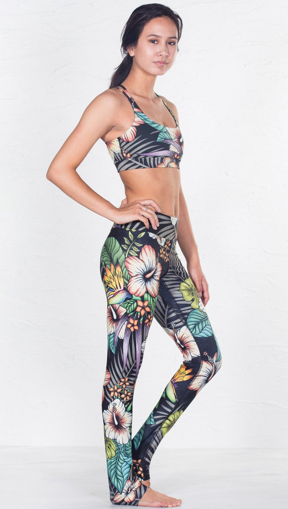 right side view of model wearing tropical flower inspired printed sports bra