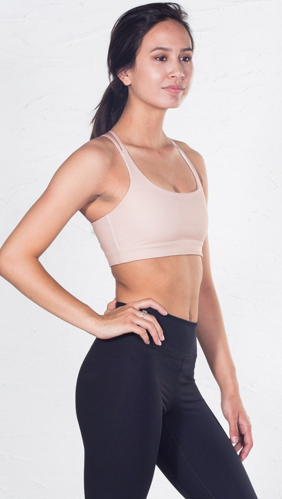 right side view of model wearing nude/beige sports bra