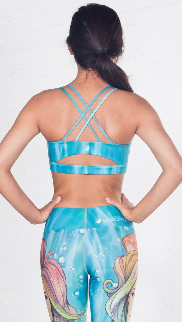 back view of model wearing aqua / ocean inspired printed sports bra 