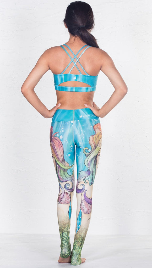 back view of model wearing aqua / ocean inspired printed sports bra 