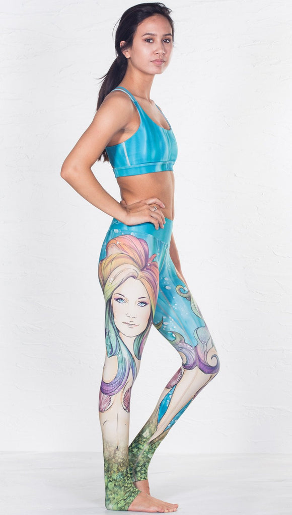 closeup right side view of model wearing aqua / ocean inspired printed sports bra 