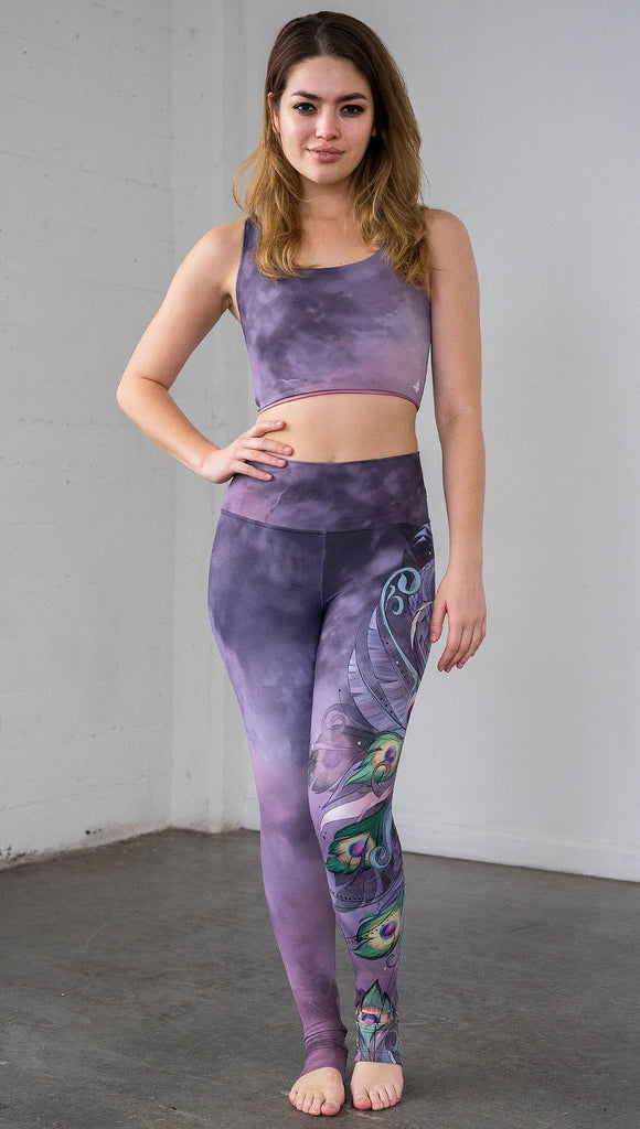 front view of model wearing peacock themed full length leggings