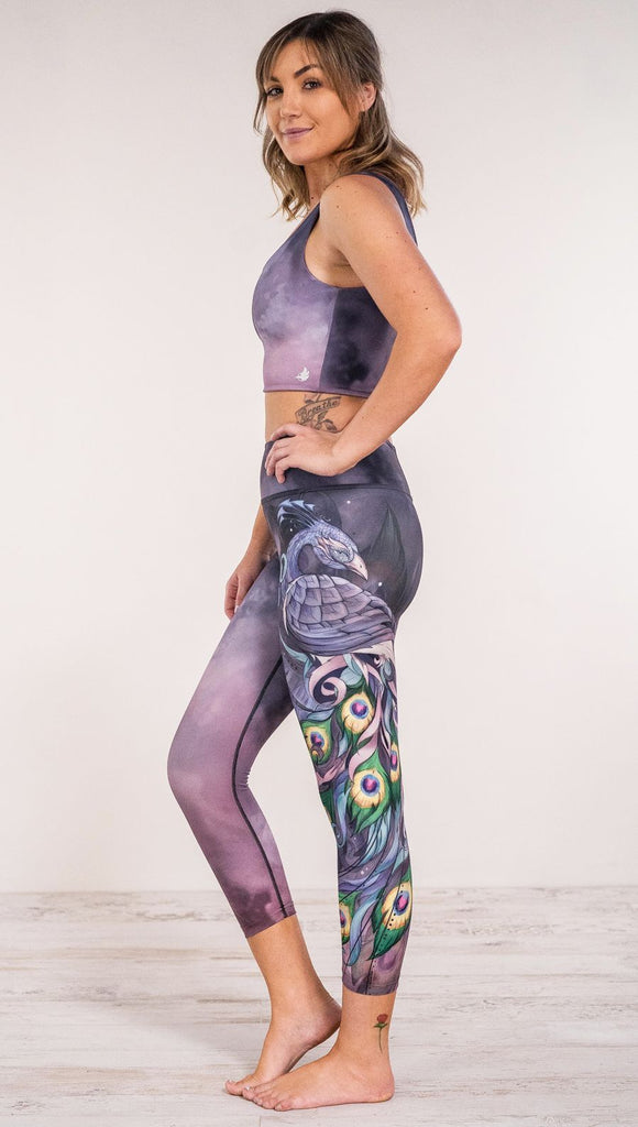 Side view of model wearing peacock themed leggings