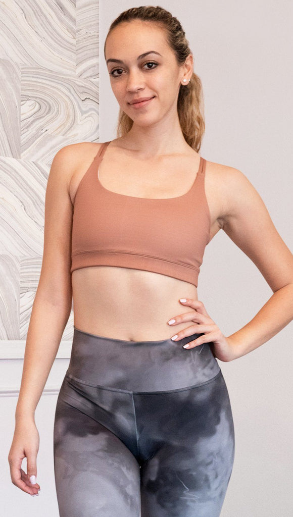 front view of model wearing brown cinnamon colored sports bra