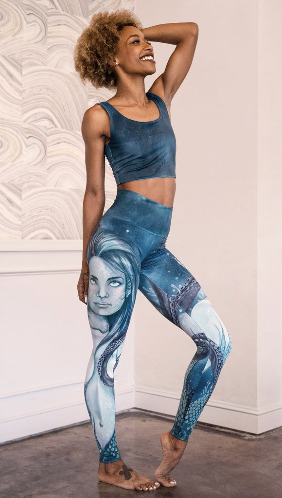 right side view of model wearing full length leggings with mermaid and tentacles printed design